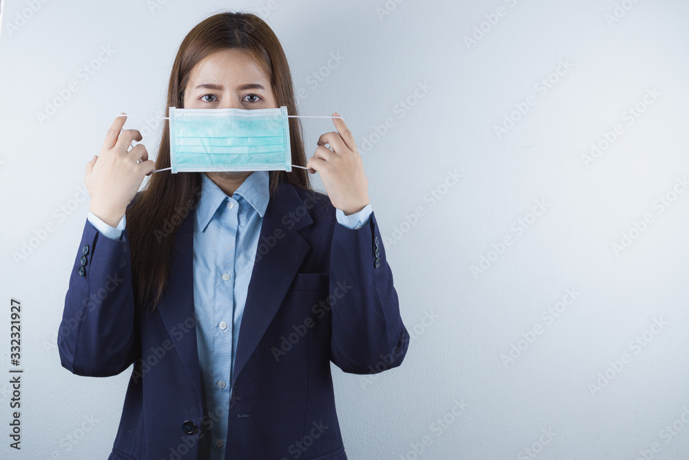 The business woman wearing protection face mask against coronavirus, PM 2.5 and cold. Coronavirus and Air pollution pm 2.5 concept. The business woman wearing protection face mask against coronavirus, PM 2.5 and cold. Coronavirus and Air pollution pm 2.5 concept.