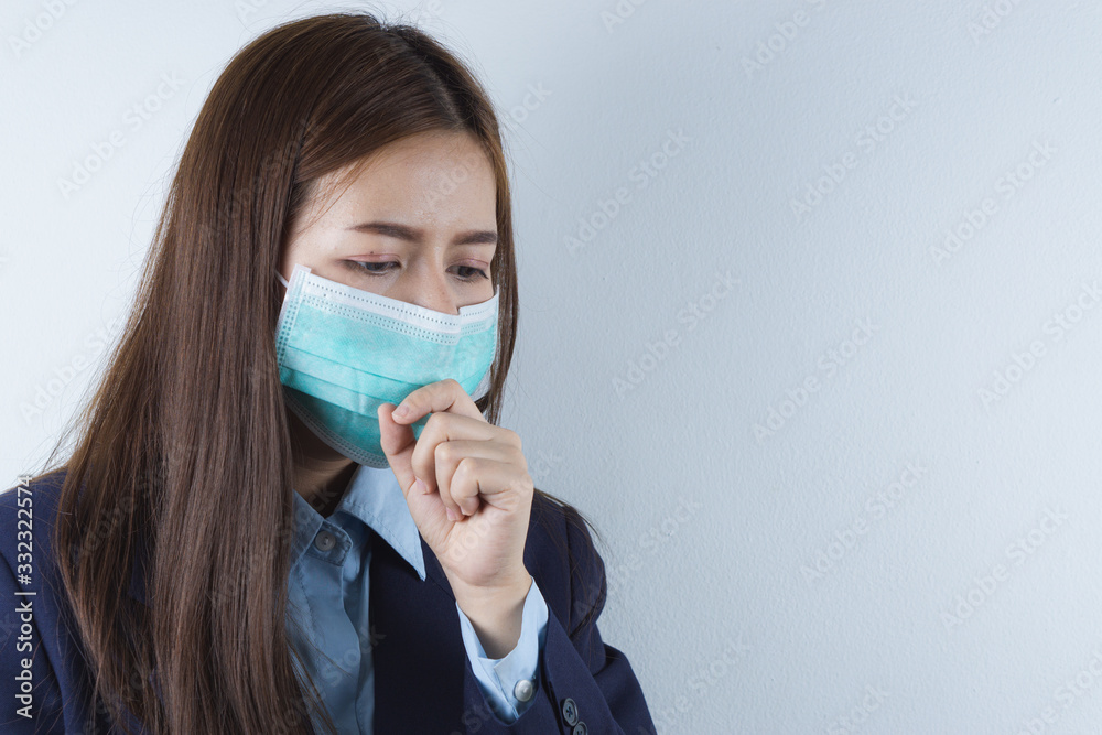 The business girl wearing mask for protecting coronavirus and pm 2.5 and she coughing flu from coronavirus. Coronavirus and Air pollution pm 2.5 concept. The business girl wearing mask for protecting coronavirus and pm 2.5 and she coughing flu from coronavirus. Coronavirus and Air pollution pm 2.5 concept.