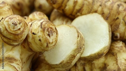 My Movie panning fresh Jerusalem artichoke on wooden