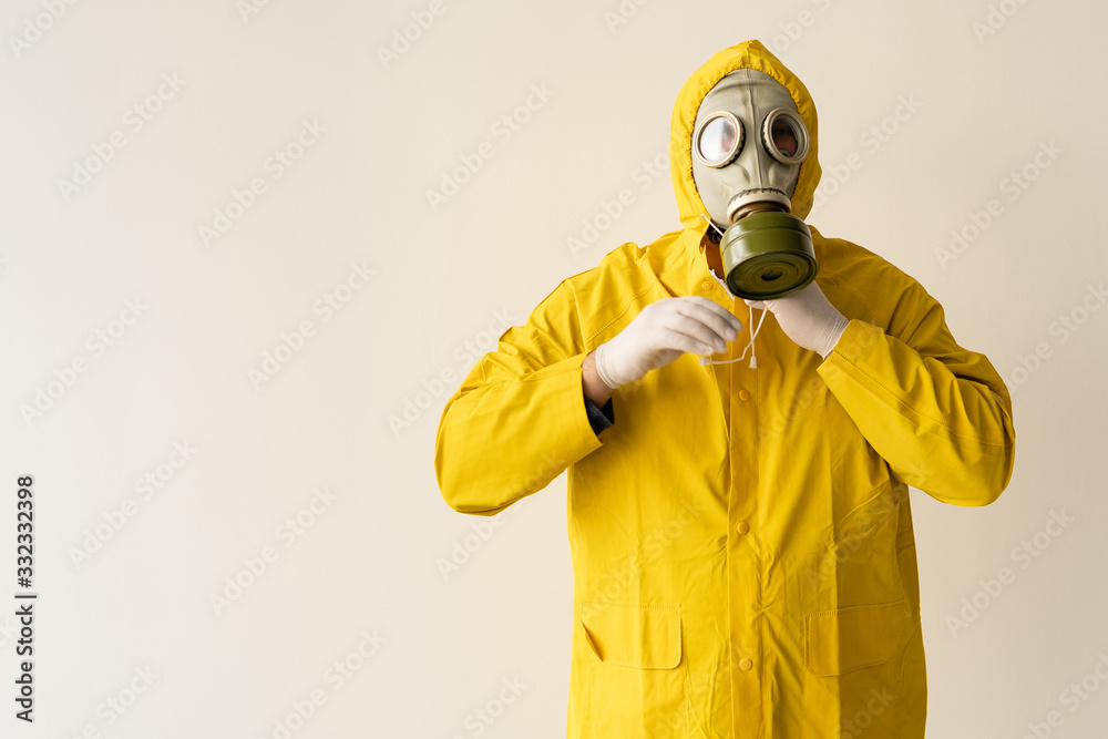 a man puts on a protective suit. Laboratory and protection against viruses. Gas mask on the face. a man puts on a protective suit. Laboratory and protection against viruses. Gas mask on the face.