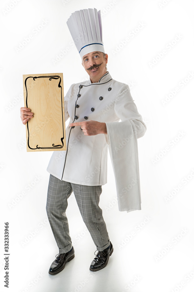 Elegant chef cook points to a nameplate for a menu or recipe Elegant chef cook points to a nameplate for a menu or recipe