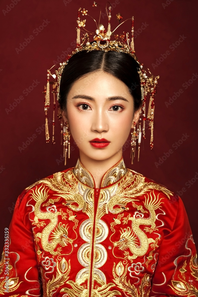 Asian brides dressed in red wedding retro clothes on a red background