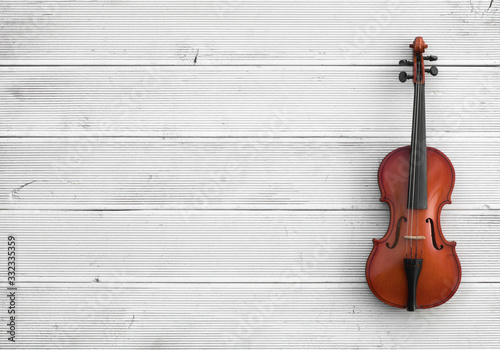 vintage violin on a white wooden background © serikbaib