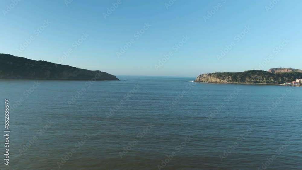 Rocky gorge leading to the endless ocean with calm water seen from shallow lagoon on beautiful coastline of Portugal Rocky gorge leading to the endless ocean with calm water seen from shallow lagoon on beautiful coastline of Portugal