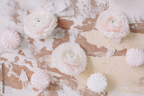 Spring wallpaper. Pink rose flowers and marshmallows on a white background. Flowers composition. Flat lay, top view, copy space. 