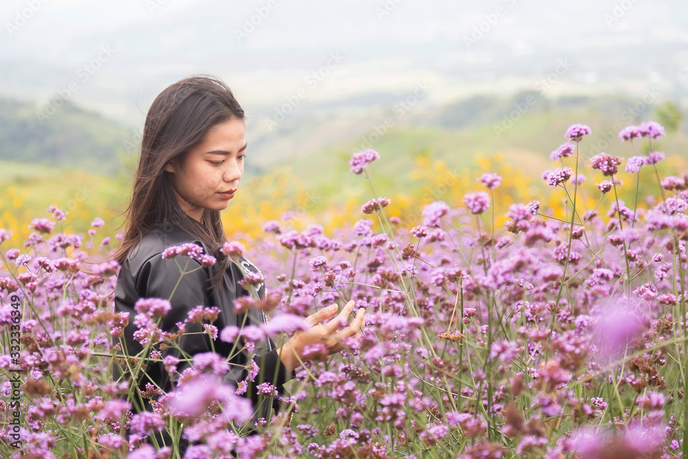 Asian women are standing to admire the beauty of flowers in the mountain gardens at Phetchabun province , Thailand. Travel with family cancept. Asian women are standing to admire the beauty of flowers in the mountain gardens at Phetchabun province , Thailand. Travel with family cancept.