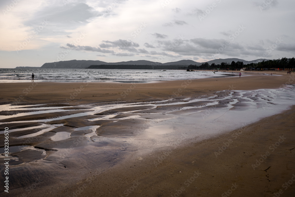 beautiful reflexions in the water at the beach in goa, india