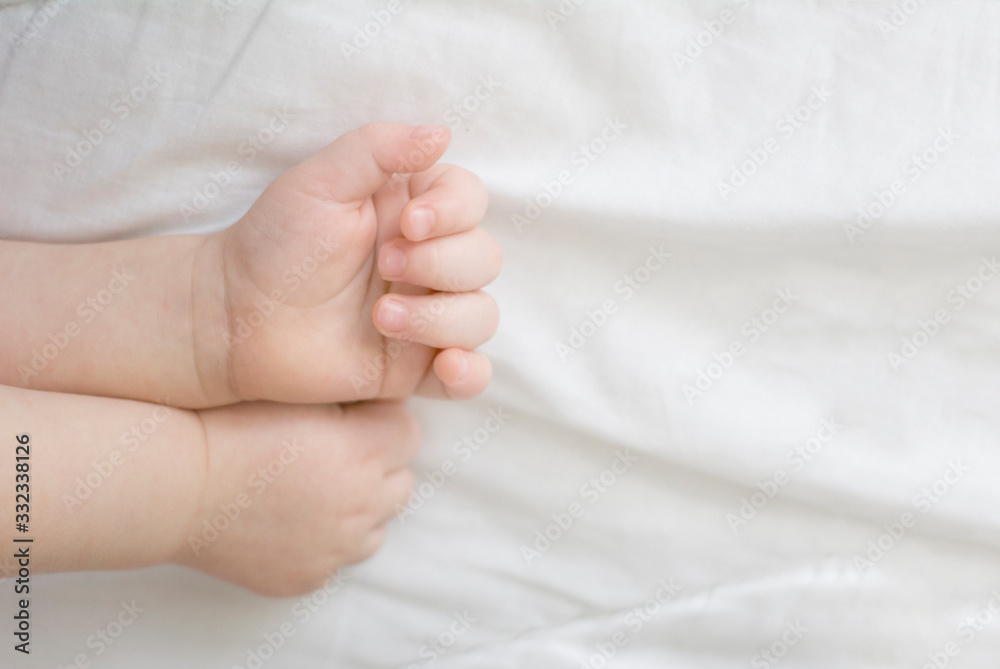 hands of a sleeping baby in the form of a heart on a white background. A child's dream hands of a sleeping baby in the form of a heart on a white background. A child's dream