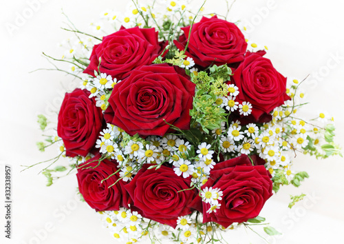 Fototapeta Naklejka Na Ścianę i Meble -  Romantic and colorful flower wedding bouquet with red roses and romantic white chamomile flowers 