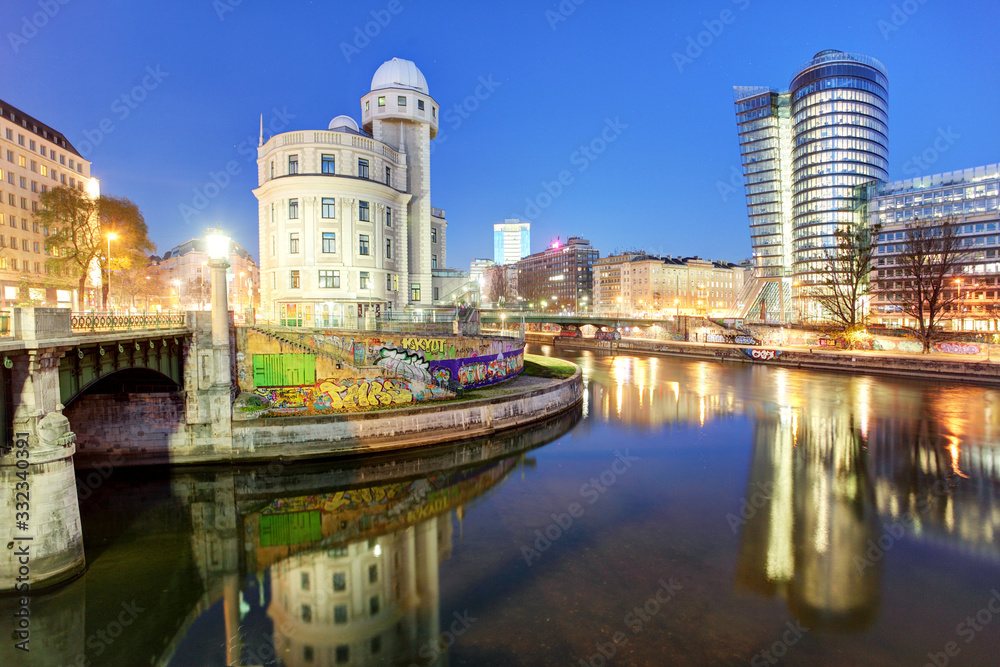 Danube Canal of Vienna, Austria. At the right the new UNIQA-Tower and opposite the historic building Urania.