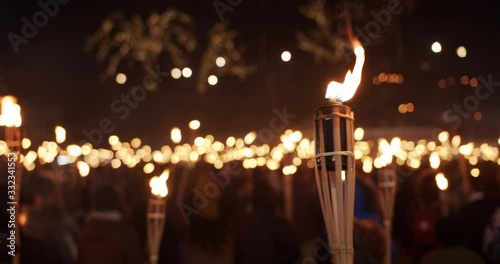 Torchlight procession at night people protest with burning torches photo