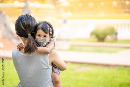 Mum and daughter Standing at Temple in Thailand wearing face mask protect filter against air pollution (pm2.5) and Covid 19 photo