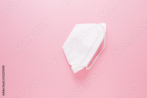 White medical mask on a pink background. Virus protection. Covid19