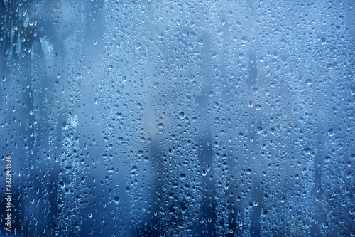 Rainy background, rain water drops on the window or in shower stall, autumn season backdrop, abstract textured wallpaper © timonko