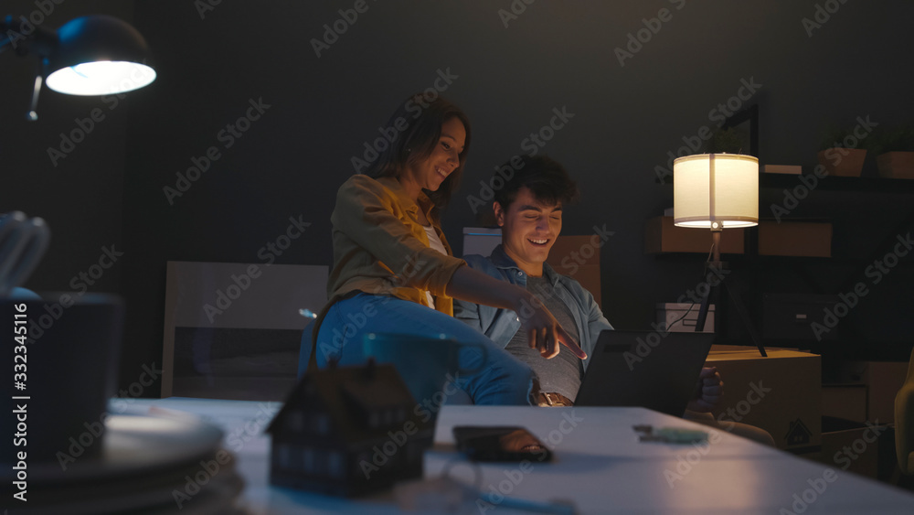 Happy couple connecting online while relocating Happy couple connecting online while relocating