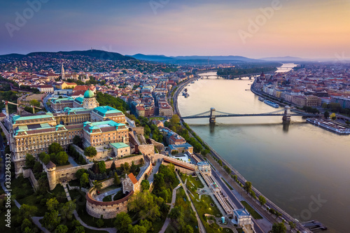 Budapest, Hungary - Aerial skyline view of Buda Castle Royal Palace and South Rondella with Castle District and Szechenyi Chain Bridge at sunrise