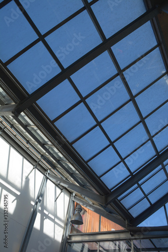 modern internal structure of glass roof construction with lockable windows sections  inside view of modern glass roof