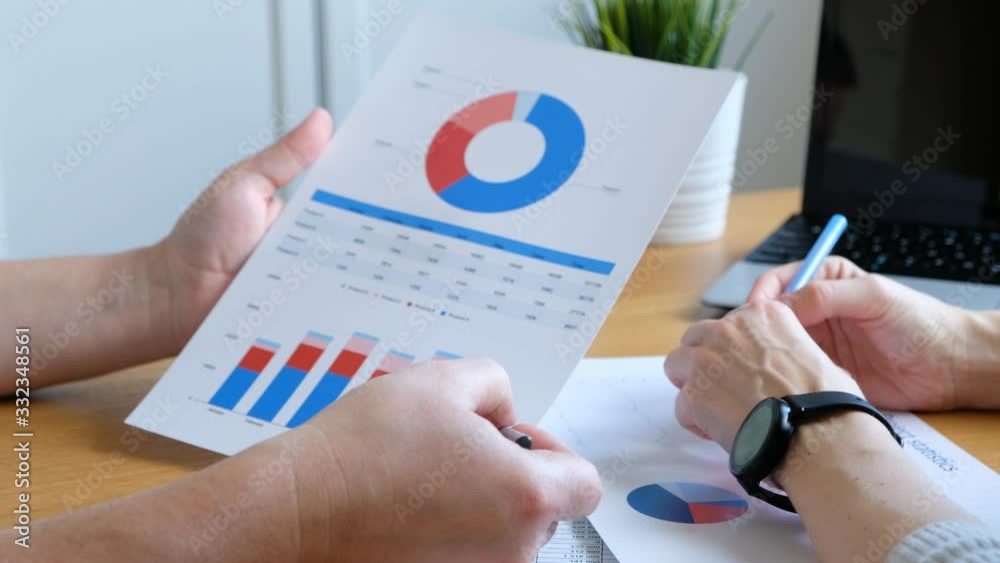 Woman and man working with business diagramm at home office, close up
