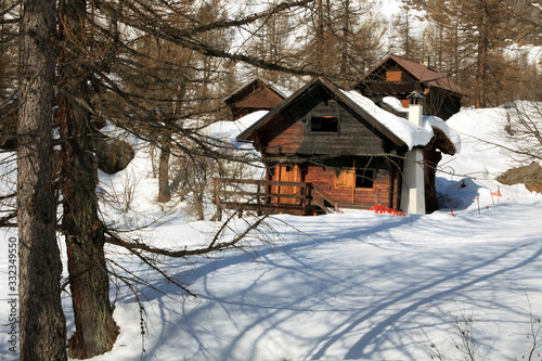 Devero Park ( Verbano-Cusio-Ossola ), Italy - January 15, 2017: Typical houses in the forest at Alpe Devero Park, Ossola Valley, VCO, Piedmont, Italy © PaoloGiovanni