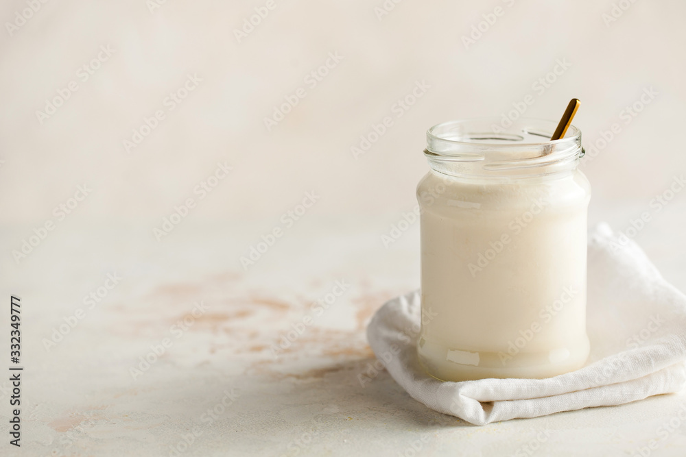 Healthy breakfast. Thermostatic fermented milk product yogurt in a glass jar with space for text on the left. Healthy breakfast. Thermostatic fermented milk product yogurt in a glass jar with space for text on the left.