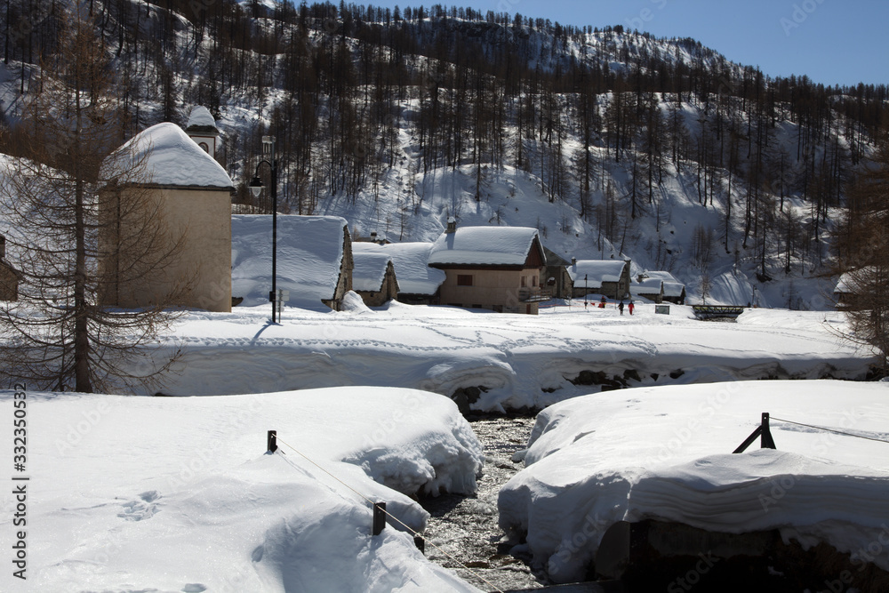 Devero Park ( Verbano-Cusio-Ossola ), Italy - January 15, 2017: Crampiolo village and houses in Alpe Devero Park, Ossola Valley, VCO, Piedmont, Italy Devero Park ( Verbano-Cusio-Ossola ), Italy - January 15, 2017: Crampiolo village and houses in Alpe Devero Park, Ossola Valley, VCO, Piedmont, Italy