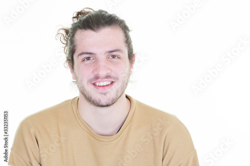 Smiling young modern man with hipster beard standing on white background
