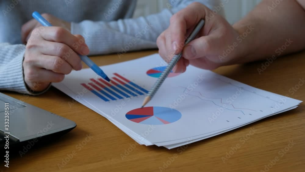 Woman and man working with business diagramm at home office, close up