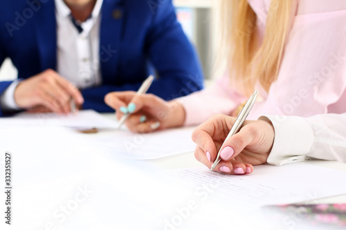 Group of people hold silver pen ready to make note in clipboard pad sheet closeup. Training course, university practice homework, school or college exercise, secretary table management concept