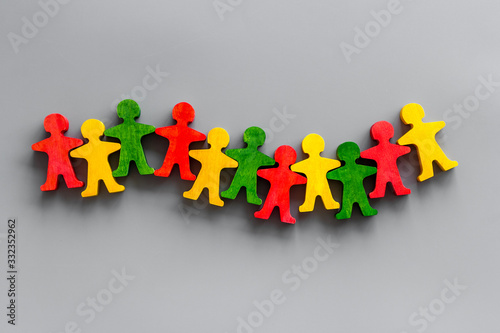 Tolerance, human rights, anti-discrination, friendship concept. Wooden figures of people on gray table, top view photo