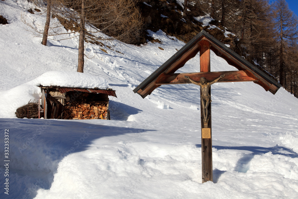 Devero Park ( Verbano-Cusio-Ossola ), Italy - January 15, 2017: A Christ wooden sculpture in Alpe Devero Park, Ossola Valley, VCO, Piedmont, Italy