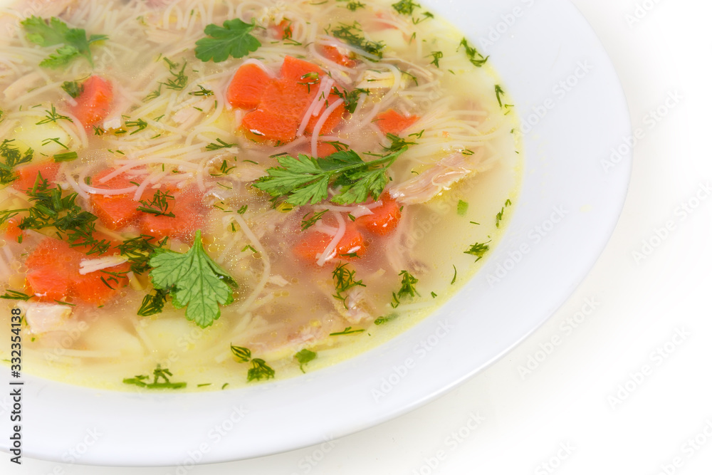 Chicken soup with thin short vermicelli in dish close-up Chicken soup with thin short vermicelli in dish close-up