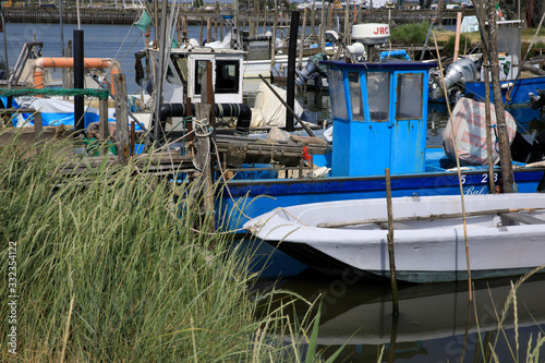 Mesola (FE),  Italy - April 30, 2017: Fish boats on Po river near Mesola, Delta Regional Park, Emilia Romagna, Italy photo