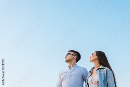 Loving couple on sky background. © Татьяна Максимова