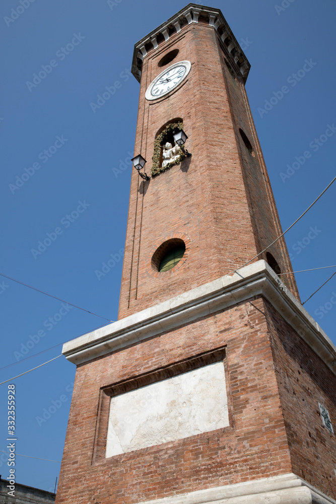 Comacchio (FE),  Italy - April 30, 2017: The clock tower in Comacchio village, Delta Regional Park, Emilia Romagna, Italy