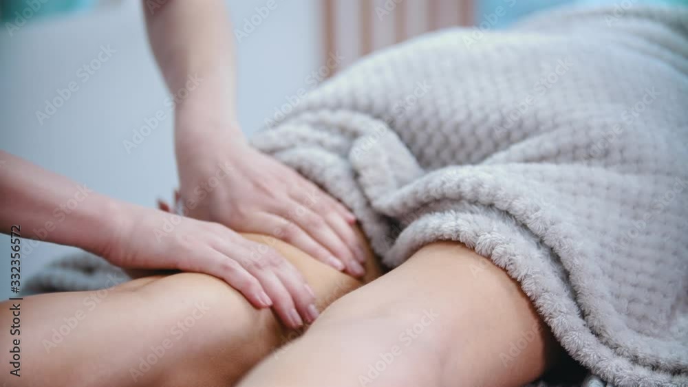 Massage - female masseuse massaging the hips of a slender woman with a special massage technique Massage - female masseuse massaging the hips of a slender woman with a special massage technique