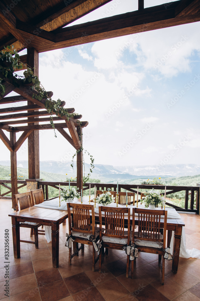 The wedding table decorated with fresh flowers is newlywed with a view of the mountains. 