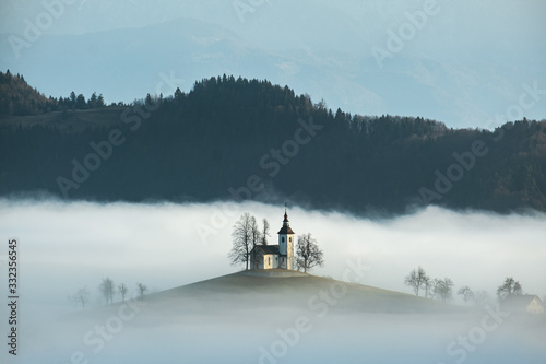 Sveti Tomaz church near skofja loka in Slovenia with low fog at sunrise © Matthew