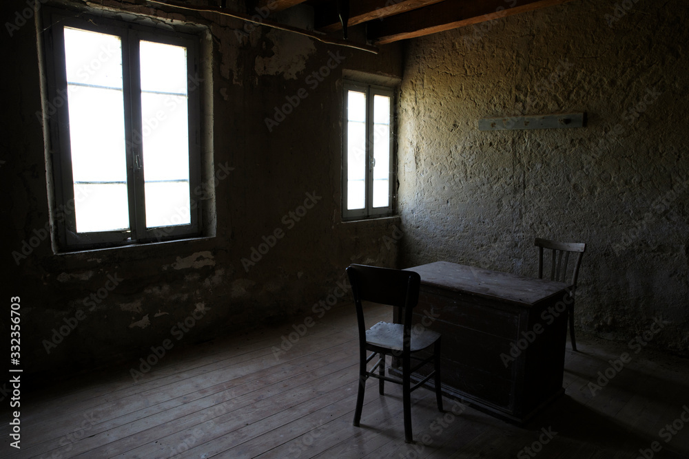 Naklejka premium Po river (FE), Italy - April 30, 2017: A old chair and table in a fisherman's houses inside on Po river, Delta Regional Park, Emilia Romagna, Italy