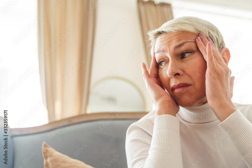 Sad elderly lady suffering from a headache Sad elderly lady suffering from a headache