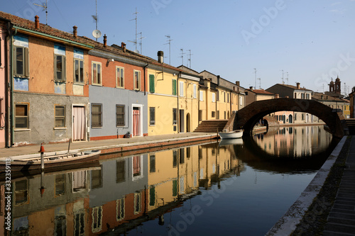 Comacchio (FE), Italy - April 30, 2017: Houses in Comacchio village reflecting in the water, Delta Regional Park, Emilia Romagna, Italy