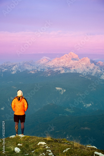 Person looking at the Julian alps on a mountain summit in Slovenia © Matthew