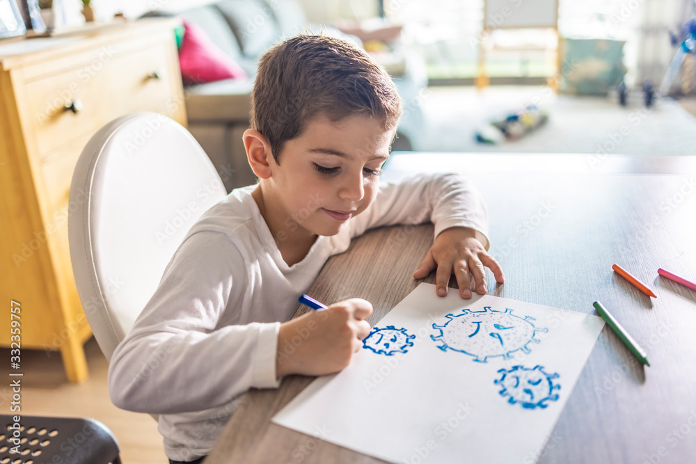 Little kid drawing a coronavirus Stock Photo