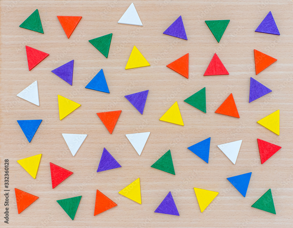 Various multi-colored geometric shapes on a wooden background. View from above. Background for text. Copy space Various multi-colored geometric shapes on a wooden background. View from above. Background for text. Copy space