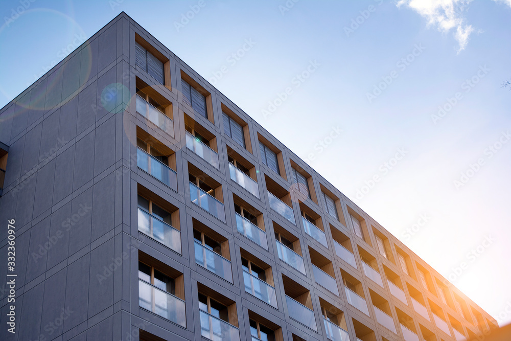 Modern apartment building exterior concept. Sunshine sun flare. 