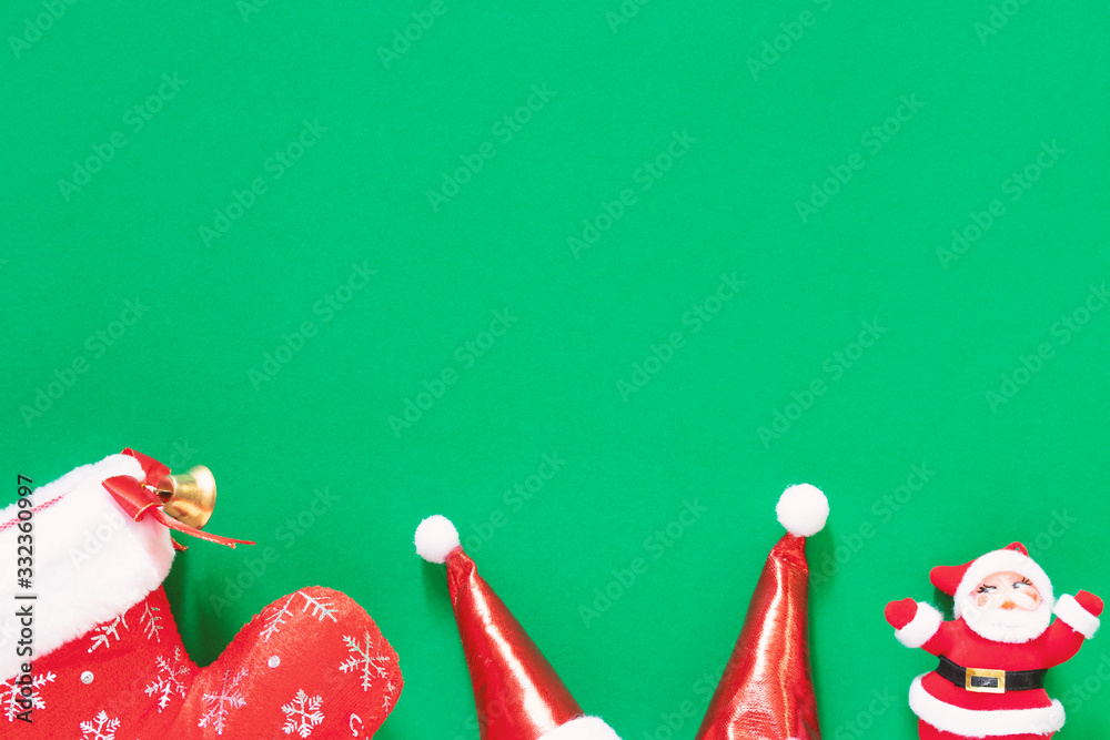Christmas present red decorating elements on green background. Flat lay, top view and copy space composition with border. Christmas decorations, Christmas, winter, Happy new year concept.