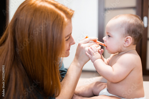 Medicine for baby. The kid receives medicine from a syringe. A mother gives a sick child medicine with a syringe.