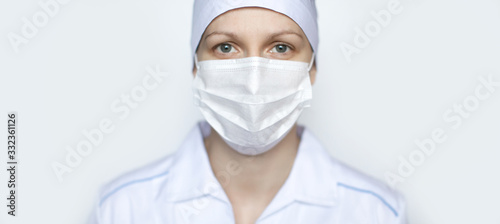 Woman doctor wearing surgical mask on white background.