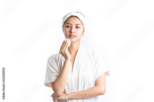 Attractive beautiful natural woman cleaning makeup from her face with cotton pad smile and looking at camera isolated on white background. Skin care and beauty concept.