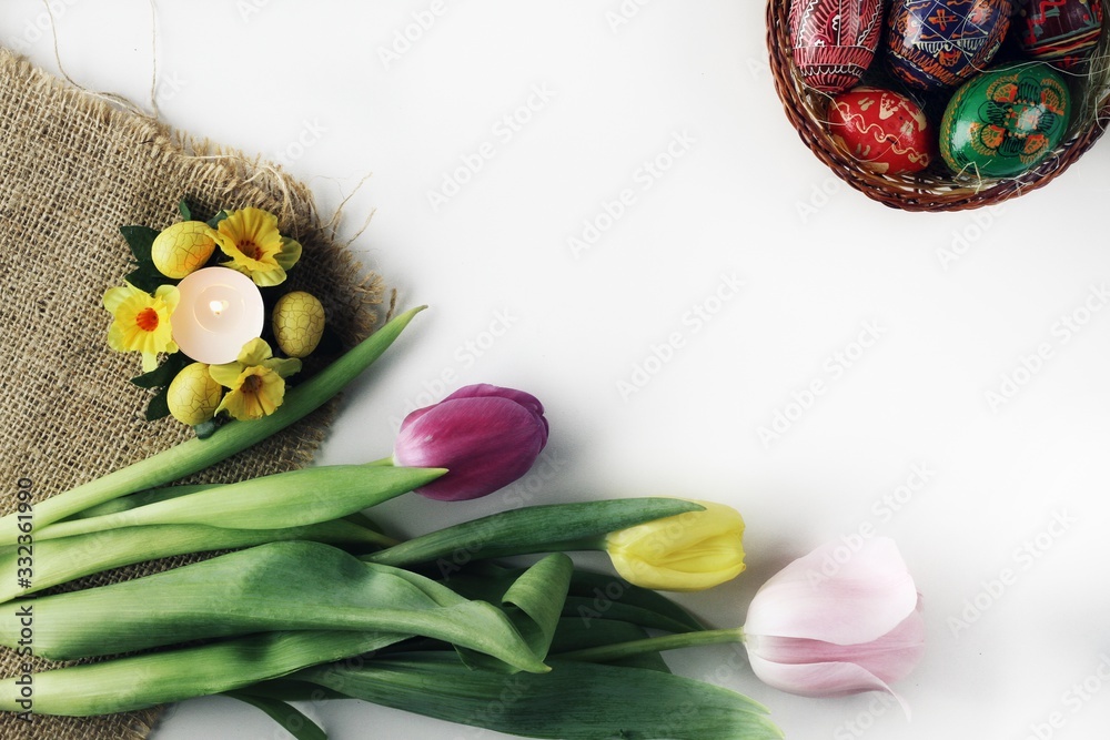 Beautiful Eastern style flat lay with traditional painted eggs and tulips