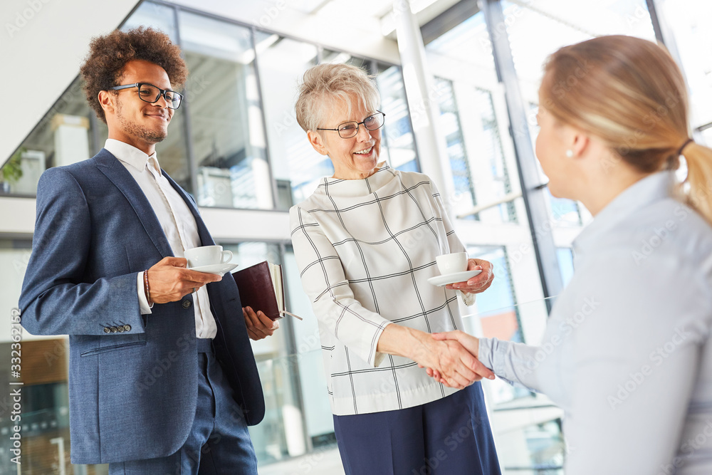 Fototapeta premium Business people greet businesswoman in wheelchair